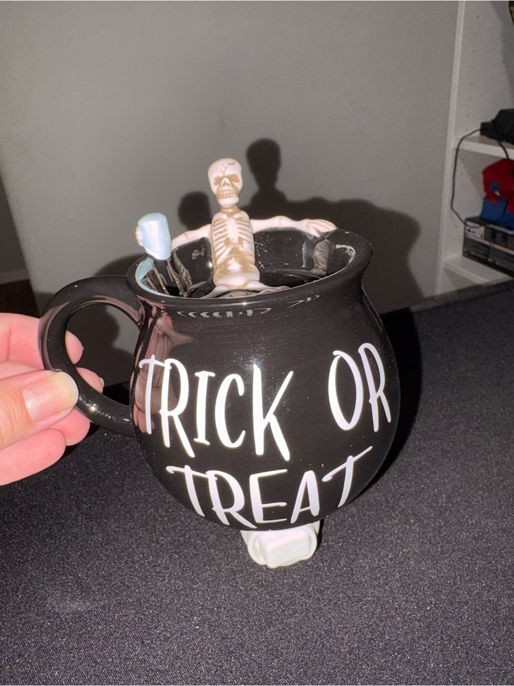 Scentsy mini warmer. Trick or treat with a skeleton sitting in the warmer top